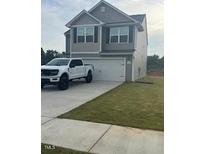 Charming two-story home with a gray exterior, front-facing garage, and a well-maintained lawn at 484 Crow Field St, Roxboro, NC 27574