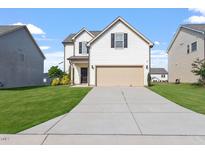 Charming two-story home with a well-maintained lawn and a two-car garage at 485 Hawksbill Dr, Franklinton, NC 27525