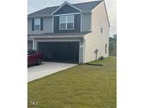 Charming two-story home with attached garage and well-manicured lawn at 512 Crow Field St, Roxboro, NC 27574