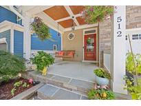 Inviting front porch with swing and charming details at 512 Mill Hopper Ln, Apex, NC 27502