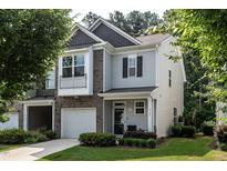 Charming townhome with attached garage, well-manicured lawn, and welcoming covered entrance at 6147 Beale Loop, Raleigh, NC 27616