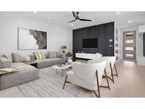 Stylish living room features modern furniture, contemporary artwork, and a sleek ceiling fan at 732 Hopkins St, Durham, NC 27701