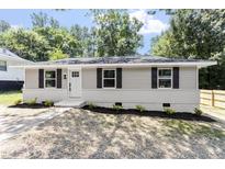 Charming single story home with gray siding, black shutters, and freshly landscaped front yard at 768 Lunar Dr, Raleigh, NC 27610