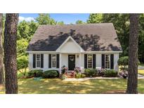 Charming single-story home with a manicured lawn and beautiful landscaping at 918 Circle Dr, Angier, NC 27501
