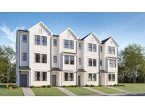 Charming new construction townhome featuring a modern farmhouse facade and a well manicured front yard at 1525 Crescent Townes Way, Raleigh, NC 27604