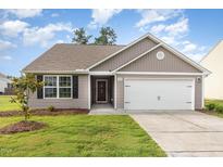 Charming single-story home featuring neutral siding, a two-car garage, and a well-manicured lawn at 2040 Alderman Way, Creedmoor, NC 27522