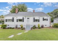 Charming home with a well-maintained lawn, stepping stone walkway, and white exterior paint at 2129 Wrenn St, Burlington, NC 27215