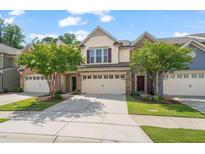 Charming townhome featuring a well-manicured lawn, neutral colors and a spacious driveway at 236 Lynchwick Ln, Durham, NC 27703