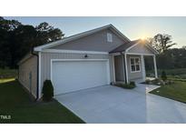Charming single-Gathering home with a two-car garage and well-manicured lawn on a sunny day at 3428 Pinnacle Peak Dr, Raleigh, NC 27604