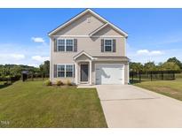 Charming two-story home with a well-manicured lawn and a one-car garage at 3641 Drafton Dr, Raleigh, NC 27610
