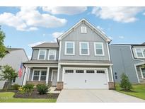 Charming two-story home with a two-car garage, gray siding, and a well-manicured lawn at 478 Curling Creek Dr, Clayton, NC 27527