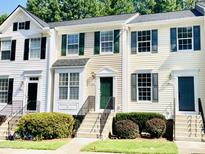 Charming townhouse with a well-maintained lawn, green shutters, and concrete stairs leading to a green front door at 5419 Vista View Ct, Raleigh, NC 27612
