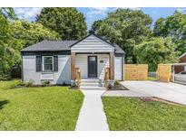 Charming home with white brick, inviting porch, and lush green lawn at 709 Brighton Rd, Raleigh, NC 27610