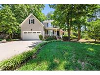Charming two-story home featuring a well-manicured lawn, a front porch, and an attached two-car garage at 8712 Walkelin Ct, Raleigh, NC 27615