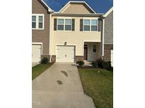 Charming townhome featuring a one-car garage and stone accents at 0416 Hazy Hls Ln, Garner, NC 27529