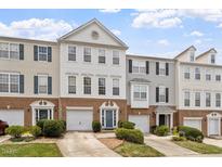 Attractive street view of townhomes with garages and well-manicured lawns on a sunny day at 110 Great Ridge Ct, Morrisville, NC 27560