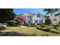 Charming two-story home with a manicured lawn and vibrant landscaping at 1106 Brittley Way, Apex, NC 27502