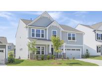 Charming two-story home with gray siding, manicured lawn, and attached two car garage at 130 Summer Mist Ln # 160, Clayton, NC 27527