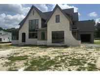 Stunning new construction home boasting a stone facade and black framed windows at 200 Meadow Walk Dr, Fuquay Varina, NC 27526