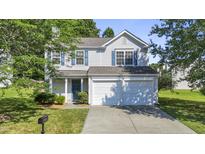 Charming two-story home with a well-maintained lawn and attached two-car garage at 211 Cloverdale Dr, Durham, NC 27703