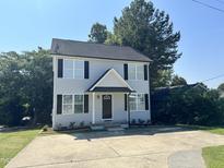 Charming two-story home featuring a welcoming entrance and a spacious driveway at 2907 S S Roxboro St, Durham, NC 27707