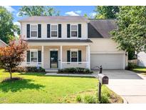 Charming two-story home with a welcoming front porch and a well-manicured lawn at 3201 Sawyers Mill Dr, Apex, NC 27539