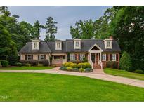 Charming traditional home featuring dormer windows and a well-manicured front lawn with mature landscaping at 4517 Gates St, Raleigh, NC 27609