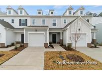 Charming townhome with a single-car garage and inviting entrance at 67 Little Leaf Ln # 98, Clayton, NC 27527