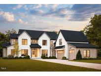 Stunning two-story home with a modern farmhouse aesthetic, complemented by lush green landscaping at 8016 Penny Rd, Raleigh, NC 27606