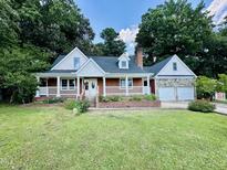 Charming home with a brick foundation, front porch, and an attached two-car garage at 101 Creekside Dr, Selma, NC 27576