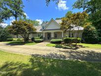 Charming brick home with manicured landscaping and a circular driveway, perfect for curb appeal at 101 Painted Rock Ct, Garner, NC 27529