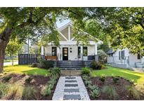 Charming home with manicured lawn, walkway, and inviting front porch at 1103 S Bloodworth St, Raleigh, NC 27601