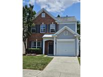 Two-story home featuring a combination of brick and gray siding and an attached garage at 121 Brentfield Loop, Morrisville, NC 27560