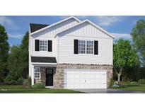 New two-story home with white siding, stone accents, a black front door, and a two-car garage at 136 Global Ave, Fuquay Varina, NC 27526