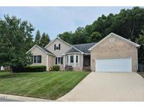 Charming two-story home with a manicured lawn, brick accents, and an attached two-car garage at 2271 Sunberry Dr, Graham, NC 27253