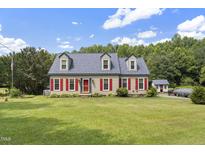 Charming home featuring red shutters, a well-manicured lawn, and beautiful curb appeal at 3573 Northern Estates Cir, Rocky Mount, NC 27804