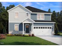 Charming two-story home featuring a two-car garage, well-manicured lawn, and welcoming front porch at 3813 Rosebush Dr, Zebulon, NC 27597