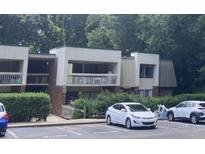 Well-maintained condo building with lush greenery and convenient visitor parking at 500 Umstead Dr # D307, Chapel Hill, NC 27516