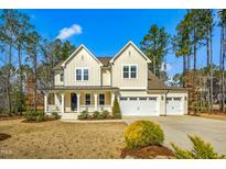 Charming two-story home featuring a welcoming front porch and a spacious three-car garage at 5148 Glen Creek Trl, Garner, NC 27529