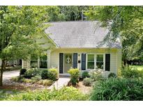 Charming home featuring a well-manicured front yard, a light exterior, and a welcoming entrance at 711 W Carver St, Durham, NC 27704