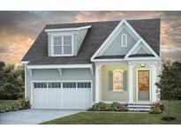 Charming two-story home featuring a front-entry garage, covered porch, and beautifully landscaped yard at 1205 Barreto Dr, Wendell, NC 27591