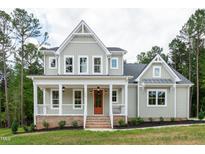 Charming two-story home with a welcoming front porch and a bright orange front door at 150 Purslane Dr, Franklinton, NC 27525