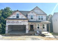 Exterior elevation of an unfinished two-story home with a two-car garage and covered porch at 177 Millwood Dr, Clayton, NC 27527