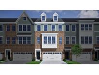 Charming townhome with brick and siding exterior, dormer windows, and attached two-car garage at 2118 Pink Peony Cir # 151, Durham, NC 27703