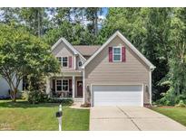 Charming two-story home featuring a well-manicured lawn and a two-car garage at 213 N Weststone Blvd, Fuquay Varina, NC 27526