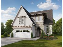 Charming two-story home featuring stone accents, a two-car garage, and a beautifully landscaped front yard at 308 Mulberry St, Raleigh, NC 27604