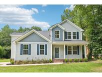 Charming two-story home featuring light gray siding and contrasting blue shutters at 3119 Berwick Dr, Burlington, NC 27215