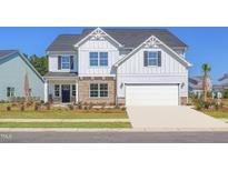 Charming two-story home with stone accents, manicured lawn and attached two car garage at 4106 Sweet Ivy Lndg # 179, Durham, NC 27703