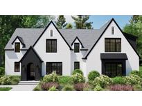 Stunning new construction featuring a white brick facade, sleek black trim, and manicured landscaping at 4348 Coldwater Springs Dr, Raleigh, NC 27616