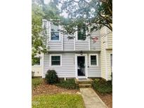 Charming gray townhome with a well-maintained front yard and inviting entrance at 4418 Roller Ct, Raleigh, NC 27604